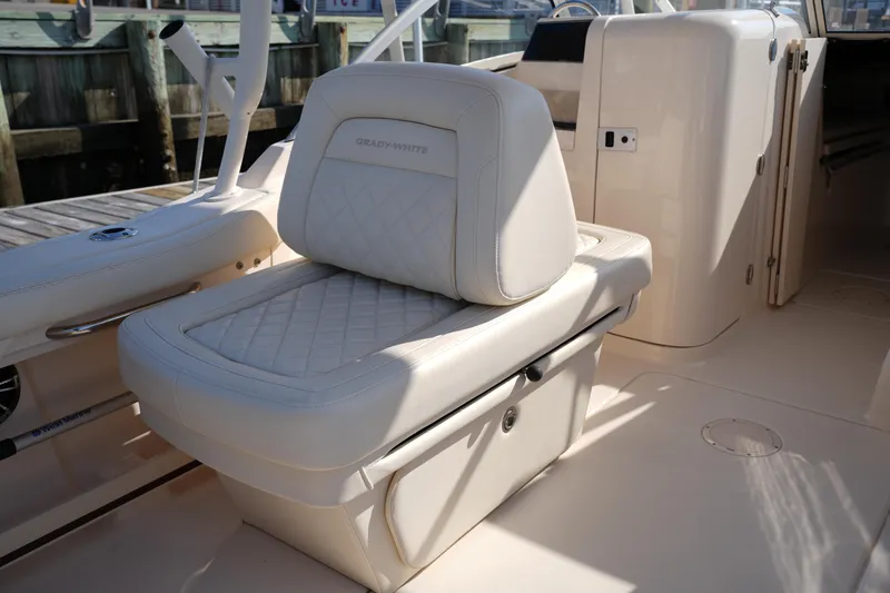 Slide: The Image of 2020 Grady-White Freedom 235 boat interior with cushioned seating and storage. - 17