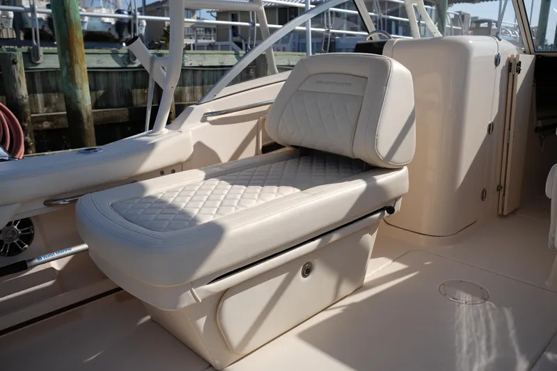 Slide: The Image of 2020 Grady-White Freedom 235 boat interior with cushioned seating and storage. - 18