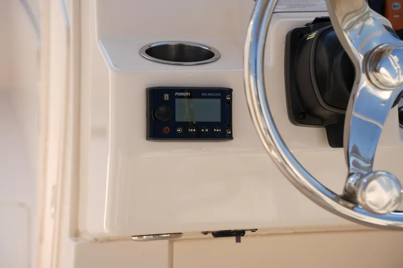 Slide: The Image of 2020 Grady-White Freedom 235 boat dashboard with Fusion MS-NRX300 stereo control. - 27