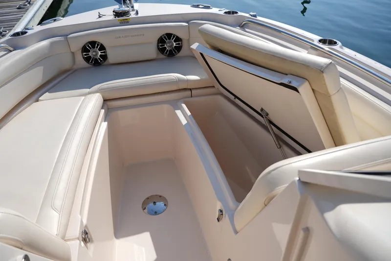 Slide: The Image of 2020 Grady-White Freedom 235 boat interior with open storage compartment and cushioned seating. - 30
