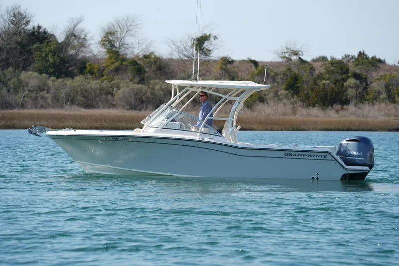 Slide: The Image of 2020 Grady-White Freedom 235 boat cruising on calm water. - 4