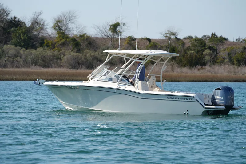 Slide: The Image of 2020 Grady-White Freedom 235 boat on calm water, side view. - 5