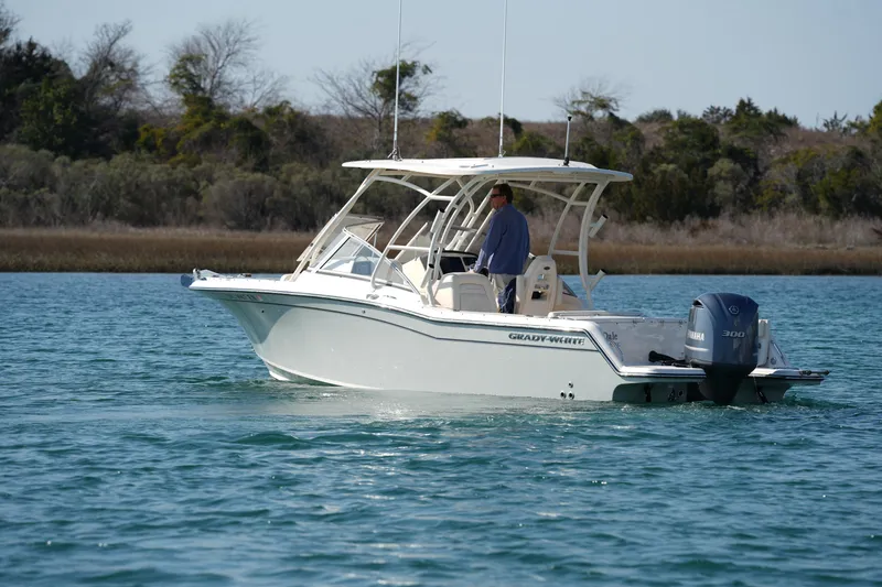 Slide: The Image of 2020 Grady-White Freedom 235 boat cruising on calm water. - 7