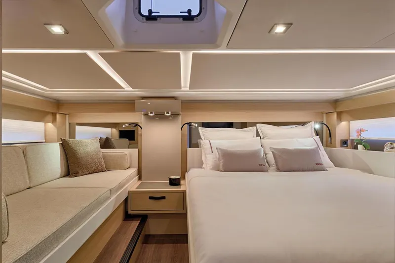 Slide: The Image of Manufacturer Provided Image: Luxurious interior of 2025 Jeanneau DB/43 OB yacht with elegant bedding and seating. - 6