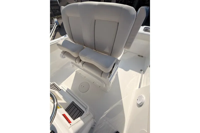 Slide: The Image of 2023 Sea Hunt Gamefish 25 boat interior with dual 150 engines, white seating, and storage compartments. - 10