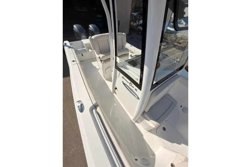 Slide: The Image of 2023 Sea Hunt Gamefish 25 boat interior with rod holders and storage compartment. - 14