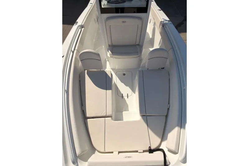 Slide: The Image of 2023 Sea Hunt Gamefish 25 boat with open storage compartments and dual Yamaha 150 engines. - 16