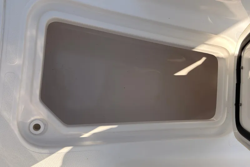 Slide: The Image of 2023 Sea Hunt Gamefish 25 storage compartment with tools and blue lighting. - 18