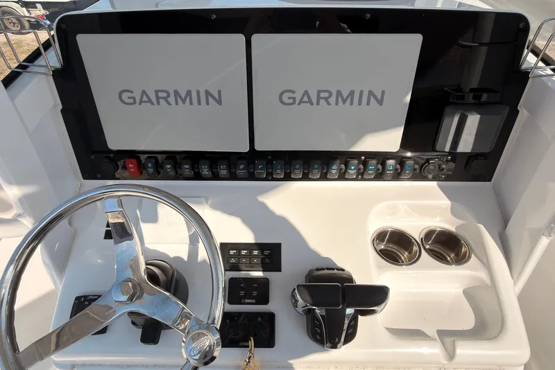 Slide: The Image of 2023 Sea Hunt Gamefish 25 boat interior with cushioned seating and storage area. - 5