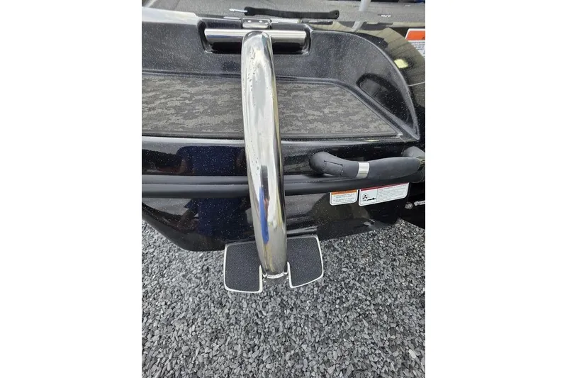 Slide: The Image of 2026 Nitro Z20 XL Pro boat rear view with step ladder on gravel surface. - 11