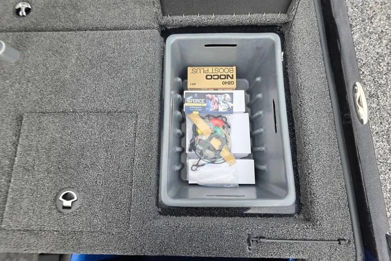 Slide: The Image of Storage compartment in 2026 Nitro Z20 XL Pro boat with accessories and NOCO Boost Plus. - 37