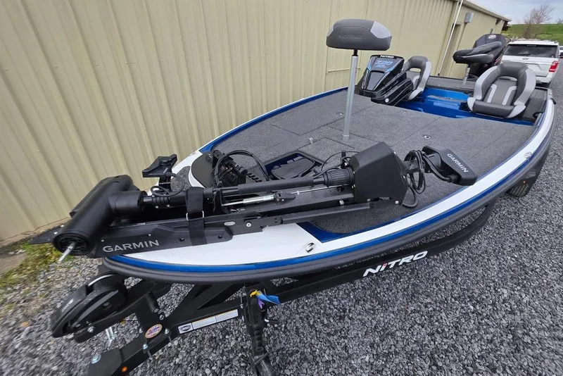 Slide: The Image of 2026 Nitro Z20 XL Pro fishing boat with Garmin equipment, parked on gravel. - 4