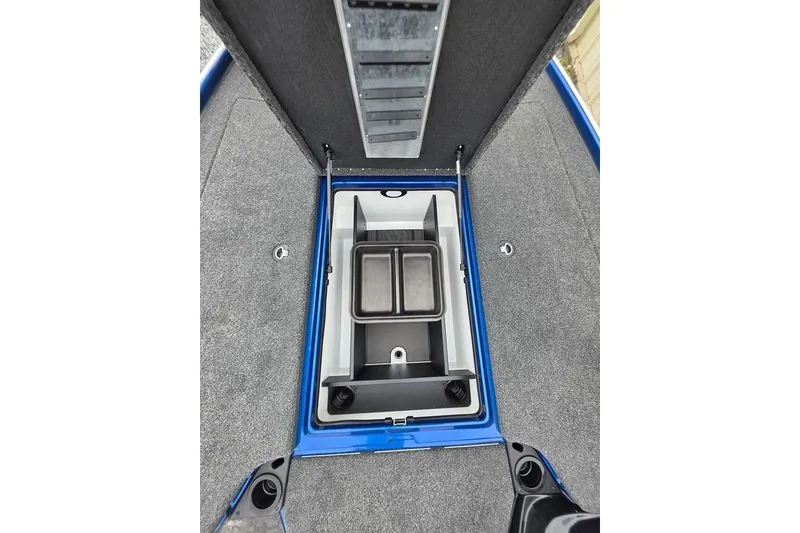 Slide: The Image of 2026 Nitro Z20 XL Pro boat storage compartment with gray carpet and blue trim. - 41