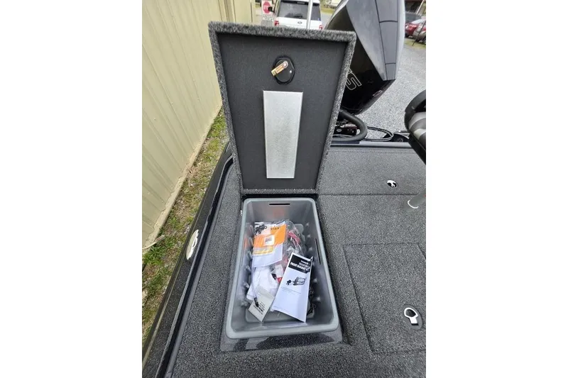 Slide: The Image of Open storage compartment in 2026 Nitro Z20 XL Pro boat, containing various items. - 45