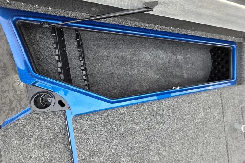 Slide: The Image of 2026 Nitro Z20 XL Pro boat storage compartment with blue trim and carpeted interior. - 50