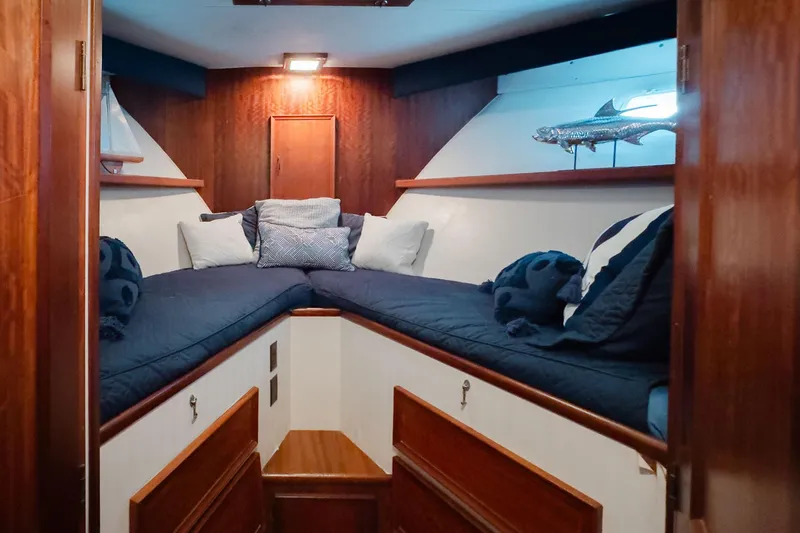 Slide: The Image of Cozy cabin interior of 1975 Hatteras 58 Long Range Cruiser with plush bedding. - 10