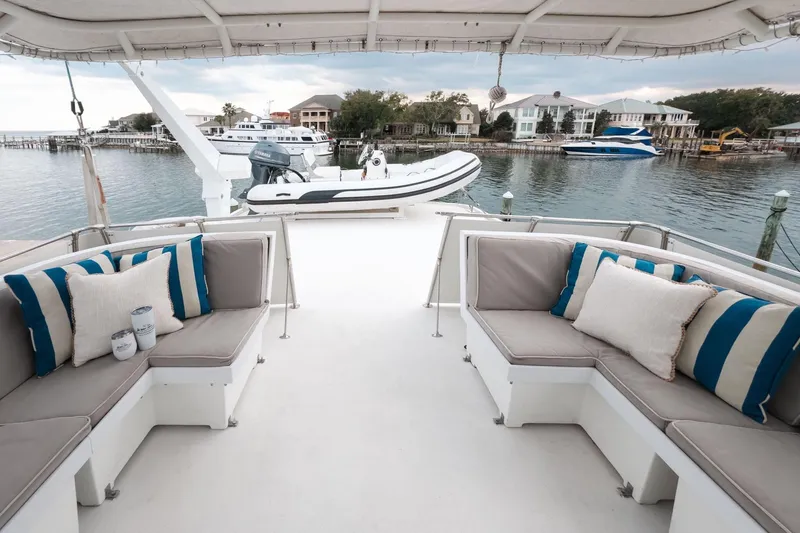 Slide: The Image of 1975 Hatteras 58 Long Range Cruiser deck with seating, overlooking marina. - 15