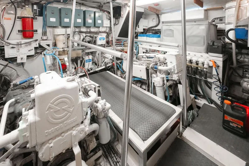 Slide: The Image of Engine room of a 1975 Hatteras 58 Long Range Cruiser, showcasing machinery and equipment. - 19