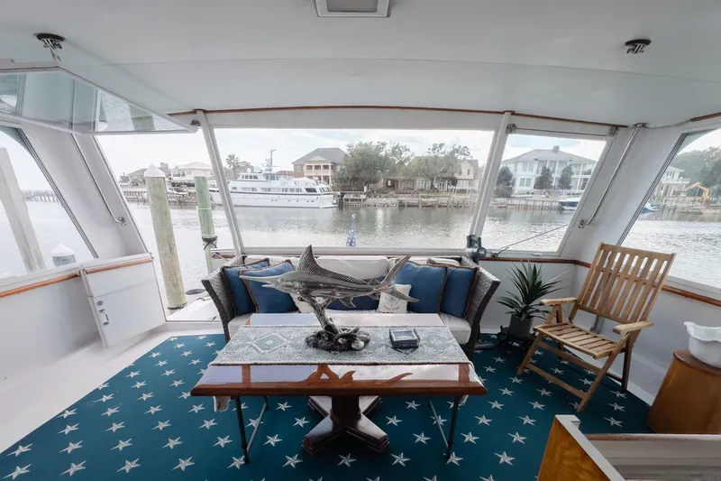 Slide: The Image of Interior of 1975 Hatteras 58 Long Range Cruiser with elegant decor and waterfront view. - 3