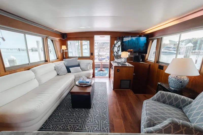 Slide: The Image of Luxurious interior of a 1975 Hatteras 58 Long Range Cruiser with elegant furnishings and large windows. - 6