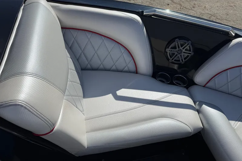 Slide: The Image of 2014 MasterCraft X30 boat interior with gray leather seats and speaker system. - 11
