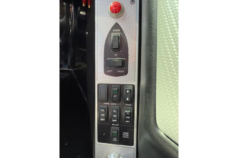 Slide: The Image of Control panel of a 2014 MasterCraft X30 boat with various switches and buttons. - 14
