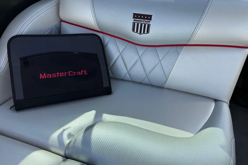 Slide: The Image of 2014 MasterCraft X30 interior with branded seat and folder, showcasing luxury design. - 19