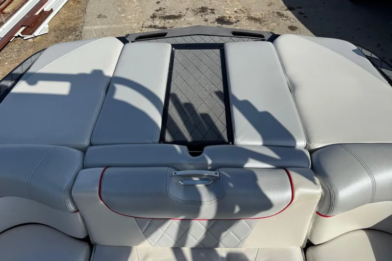 Slide: The Image of 2014 MasterCraft X30 boat interior with gray upholstery and red accents. - 20