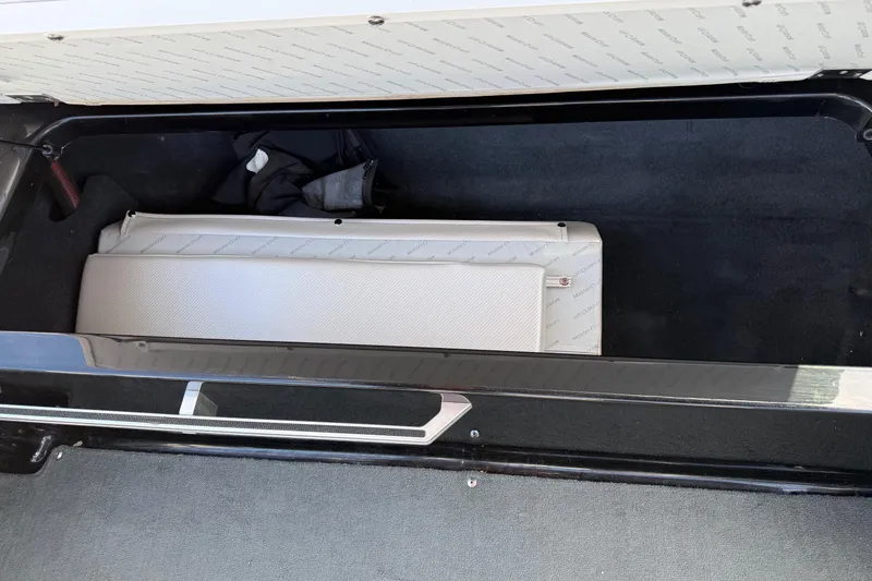 Slide: The Image of 2014 MasterCraft X30 storage compartment with cushioned interior and gear. - 22