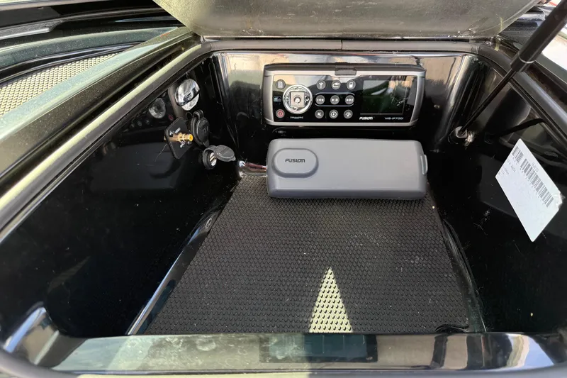 Slide: The Image of 2014 MasterCraft X30 boat storage compartment with Fusion stereo system. - 25