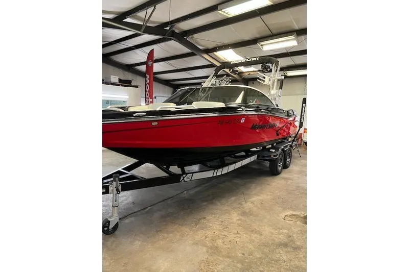 Slide: The Image of 2014 MasterCraft X30 red boat on trailer in indoor showroom. - 29