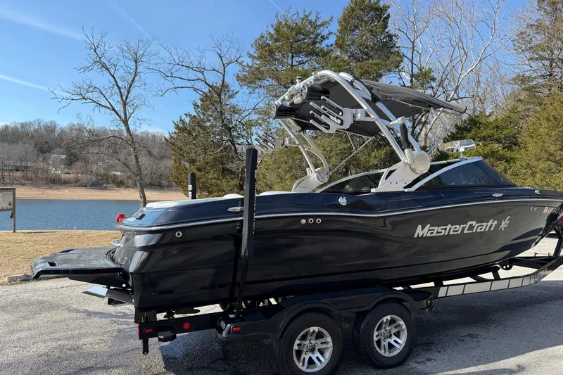 Slide: The Image of 2014 MasterCraft X30 boat on trailer by a scenic lake. - 3