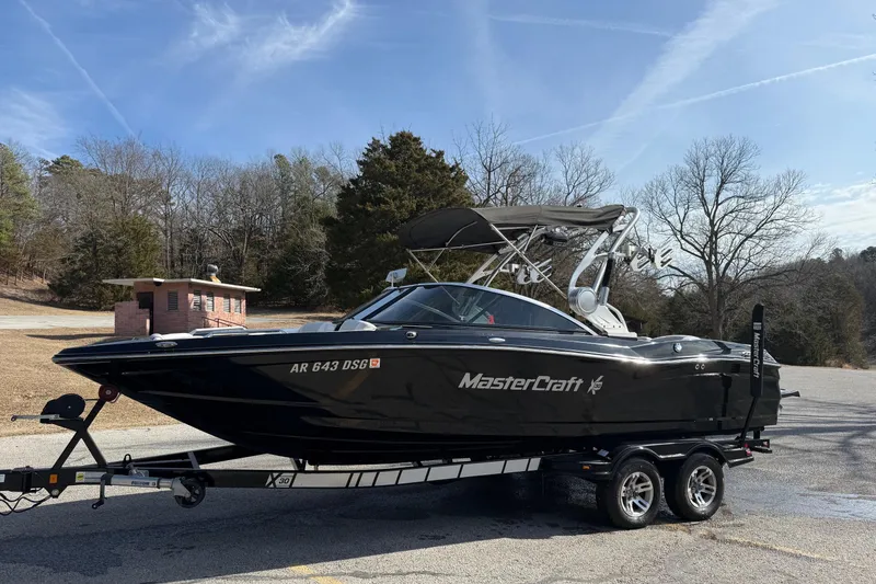 Slide: The Image of 2014 MasterCraft X30 boat on trailer in scenic outdoor setting. - 6