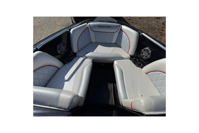 Slide: The Image of 2014 MasterCraft X30 boat interior with luxurious seating and cup holders. - 8