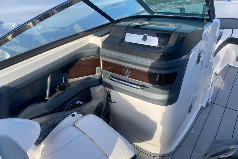 Slide: The Image of 2021 Chaparral 26 Surf boat interior with sleek dashboard and seating. - 3