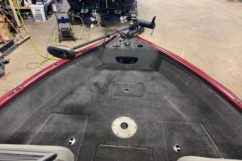 Slide: The Image of 2018 Tracker Pro Guide V-175 Combo boat interior with trolling motor in garage. - 11