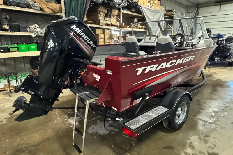 Slide: The Image of 2018 Tracker Pro Guide V-175 Combo boat with Mercury outboard in a garage. - 3