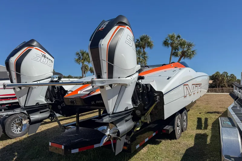 The Image of 2021 MTI 390X powerboat with dual Mercury Racing 300R engines, parked on a trailer. - 0