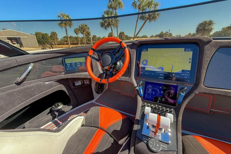 Slide: The Image of Interior of 2021 MTI 390X boat with advanced navigation system and vibrant steering wheel. - 10