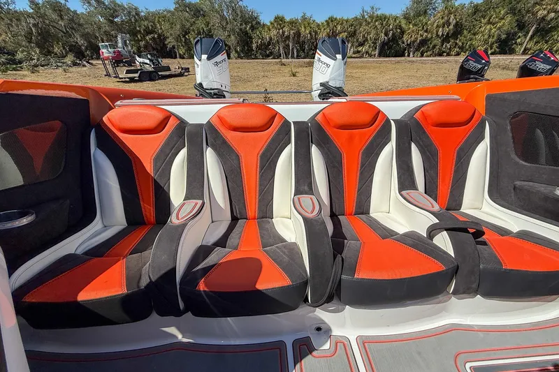 Slide: The Image of Luxury MTI 390X 2021 boat interior with vibrant orange and black seating. - 12
