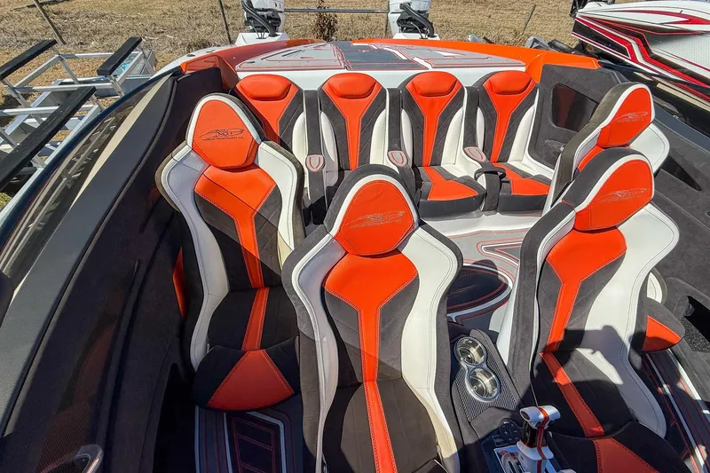 Slide: The Image of 2021 MTI 390X boat interior with vibrant red and white seating arrangement. - 13