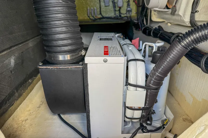 Slide: The Image of Engine compartment of 2021 MTI 390X with visible hoses and components. - 21