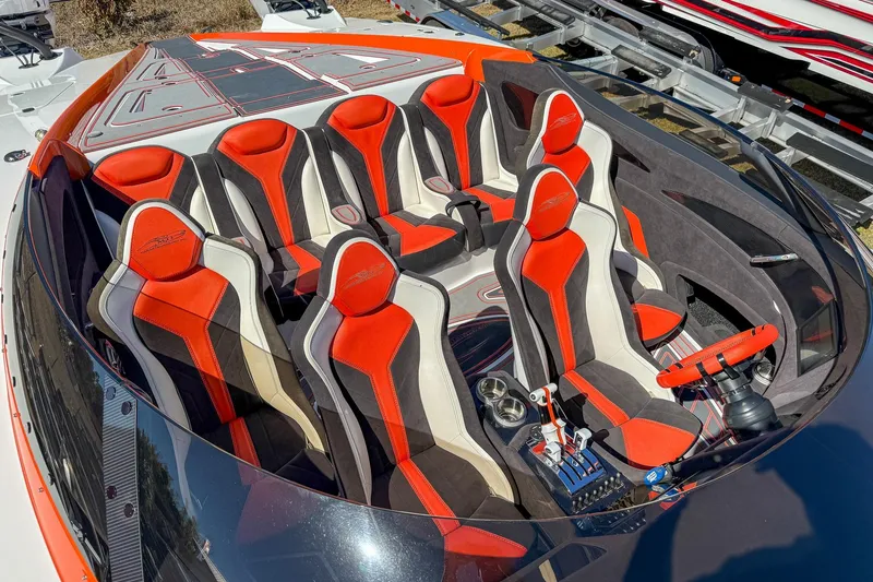 Slide: The Image of 2021 MTI 390X boat interior with red and black racing seats and steering wheel. - 5