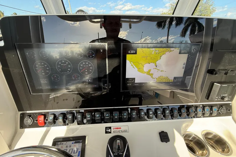 Slide: The Image of Control panel of 2021 Sea Hunt Ultra 305 SE boat with navigation screens. - 16