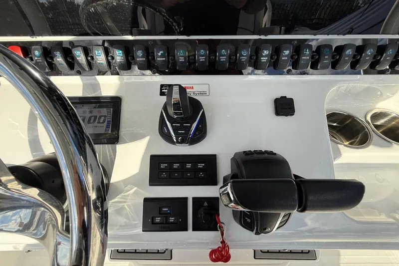 Slide: The Image of Control panel of 2021 Sea Hunt Ultra 305 SE boat with steering wheel and switches. - 18