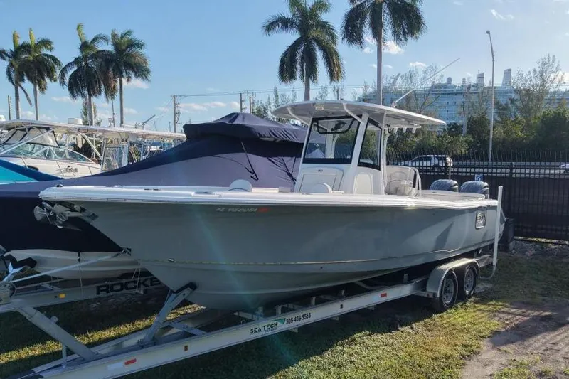 Slide: The Image of Sea Hunt Ultra 305 SE 2021 on trailer, palm trees in background. - 2