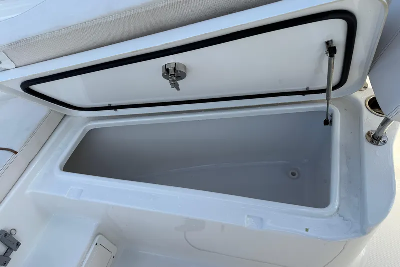 Slide: The Image of Open storage compartment on 2021 Sea Hunt Ultra 305 SE boat. - 23
