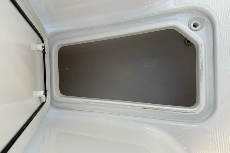 Slide: The Image of Storage compartment of 2021 Sea Hunt Ultra 305 SE boat, open and empty. - 24