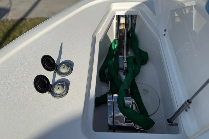 Slide: The Image of Anchor compartment of 2021 Sea Hunt Ultra 305 SE boat with green rope and fittings. - 26