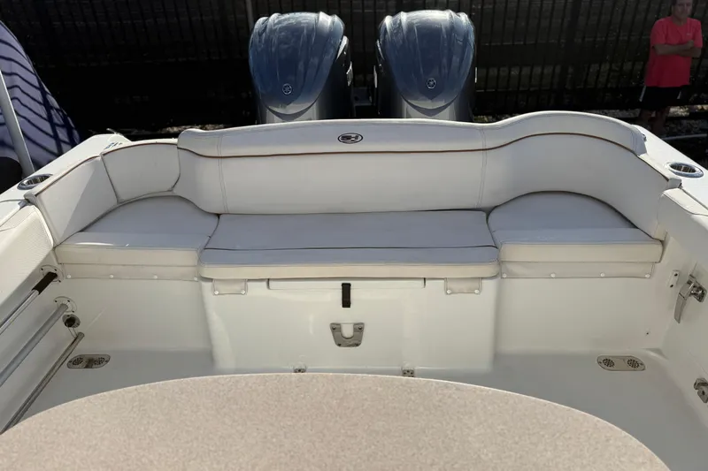 Slide: The Image of 2021 Sea Hunt Ultra 305 SE boat interior with cushioned seating and dual engines. - 28